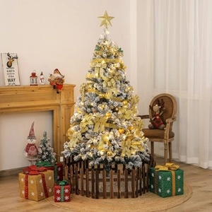 Detailed view of decorated Christmas tree with golden ornaments and wooden fence base
