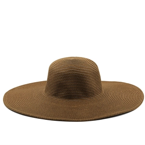 Close-up of the spiral woven texture and fine craftsmanship on this brown straw sun hat