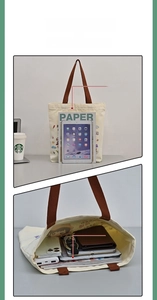 Detail view of large canvas tote bag showing zipper pocket and interior capacity space