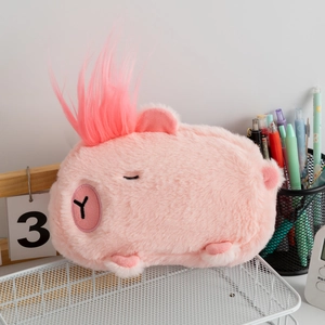 Pink fluffy capybara plush pencil case with cute embroidery on a desk organizer