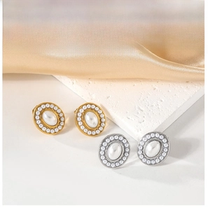 Close-up of gold and silver vintage pearl earrings on a premium marble surface