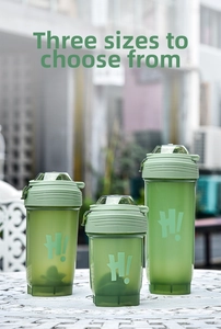 Three sizes of green matte shaker bottles with H logo on a white outdoor table