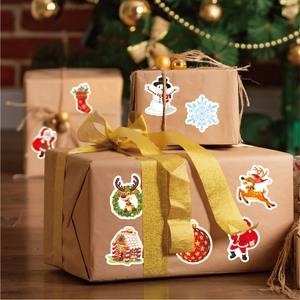 Christmas gift box decorated with laser Santa and reindeer stickers in warm holiday setting