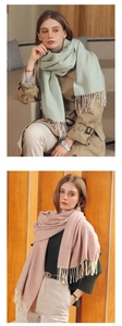 Detail view of wavy stripe texture and fringe tassels on pastel solid scarves