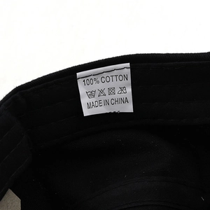 Detailed view of the 100% cotton material label inside a vintage black military flat cap