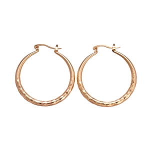 Golden geometric diamond-cut hoop earrings with a metallic textured finish and hinge clasp
