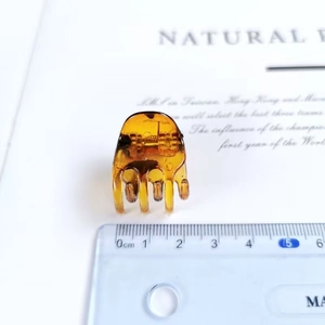 Detail view of a 2cm amber tortoiseshell hair claw clip for elegant half-up hairstyles