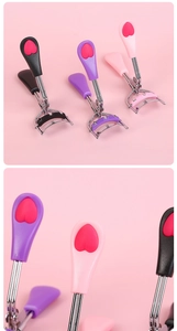 Detailed view of portable stainless steel eyelash curlers with colorful heart handles