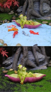 Detailed resin green frog couple sitting in a purple pea pod boat for garden micro landscapes
