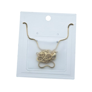 Golden swan pendant necklace on a white display card in clear self-adhesive packaging