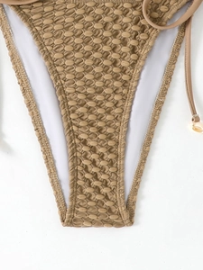 Detail of camel bikini bottoms with honeycomb texture fabric and side ties on white