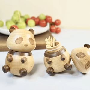 Close-up of cute panda-shaped wooden toothpick holder with lid open showing toothpicks