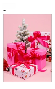 Pink Christmas gift wrapping paper with cartoon Santa patterns and silk ribbons