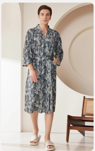 Detail of blue tropical palm leaf print bathrobe with waist tie and side pockets