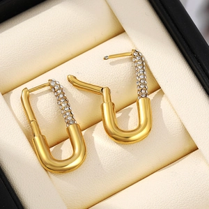 Macro shot of 18K gold plated safety pin earrings with sparkling pavé zircons