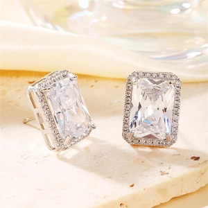 Macro detail of rectangle zircon stud earrings with silver pavé setting on stone