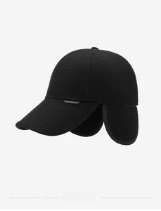 Side view of black winter baseball cap with ear flaps and premium textured warm fabric