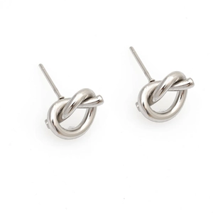 Detailed view of silver knot stud earrings with a polished finish and minimalist style