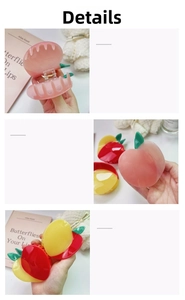 Close-up of peach and apple hair claws showing spring structure and glossy finish