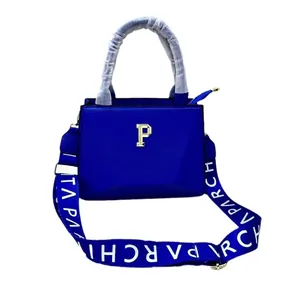 Royal blue embroidered tote bag with wide logo strap and golden letter P pendant