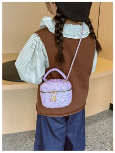 Detail shot of purple sequined quilted kids handbag with elegant chain strap and handle