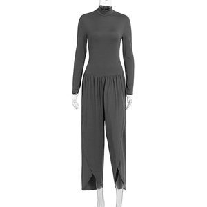 Detail of high neck long sleeve jumpsuit with layered tulip hem and wide leg fit