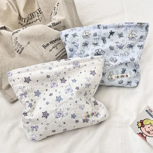 Detailed macro view of quilted makeup bags with cute cartoon patterns and side labels