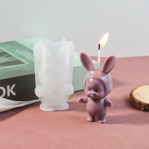 Macro view of flexible silicone mold with a sleeping baby in bunny ears candle design