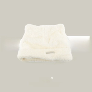 Detail of white faux mink fur knitted hat with cat ears and silver metal logo plaque