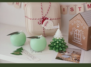 Macro detail of Christmas apple and tree shaped aromatherapy candles for holiday decor