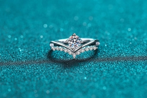 Macro shot of S925 silver V-shaped ring featuring a brilliant four-claw moissanite stone