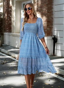 Close-up of square neckline and ruffled sleeves on blue floral tiered maxi dress