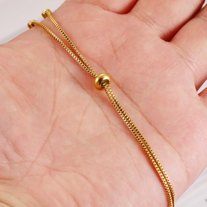 Adjustable golden stainless steel box chain bracelet with slider and crystal detail