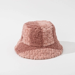 Close-up of plush bucket hat featuring pink and light brown faux fur patchwork texture