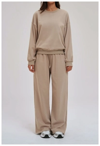 Close-up of drawstring elastic waistband and soft knit fabric on wide-leg sweatpants