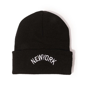 Detail of New York embroidery on thick black ribbed knit beanie for winter warmth