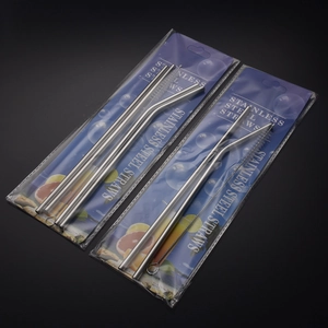 Detail of stainless steel straw set with straight, bent straws and cleaning brush