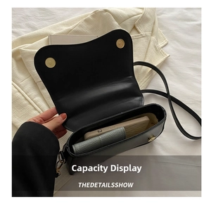 Top view of the black leather saddle bag interior showing space for a phone and wallet