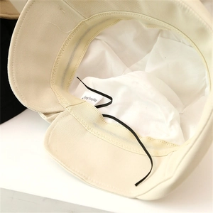 Close-up of cream sun hat interior with adjustable drawstrings and cotton lining