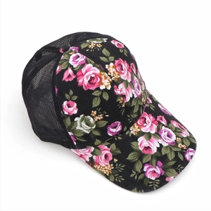Detailed close-up of a floral baseball cap featuring black breathable mesh and rose pattern