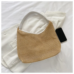 Macro detail of khaki woven straw bag with premium white leather handle for summer beach