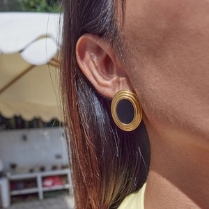 Elegant 18K gold-plated stainless steel oval earrings with black inlay on a female model