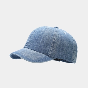 Detail of light blue washed denim baseball cap featuring contrast white stitching