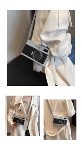 Detailed view of vintage camera-shaped crossbody bag with black and white texture