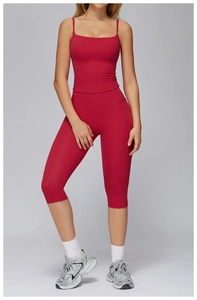 Detail of dark red yoga set featuring a slim camisole top and high-waist cropped leggings
