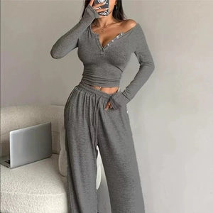 Women's grey two-piece lounge set with long sleeve V-neck top and wide leg pants
