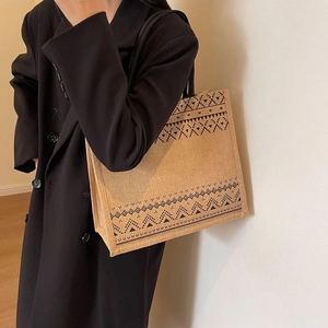 Detail of linen tote bag with geometric ethnic pattern and sturdy black handles