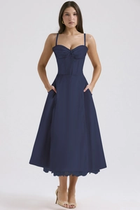 Detail of navy blue floral midi dress featuring lace-up corset waist and side pockets