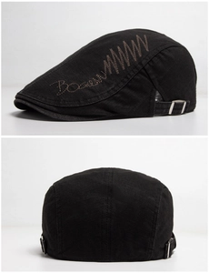 Detail of vintage black cotton beret showing embroidery and metal adjustable buckle