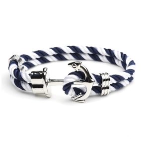 Close-up of nautical rope bracelet with blue-white stripes and silver anchor buckle